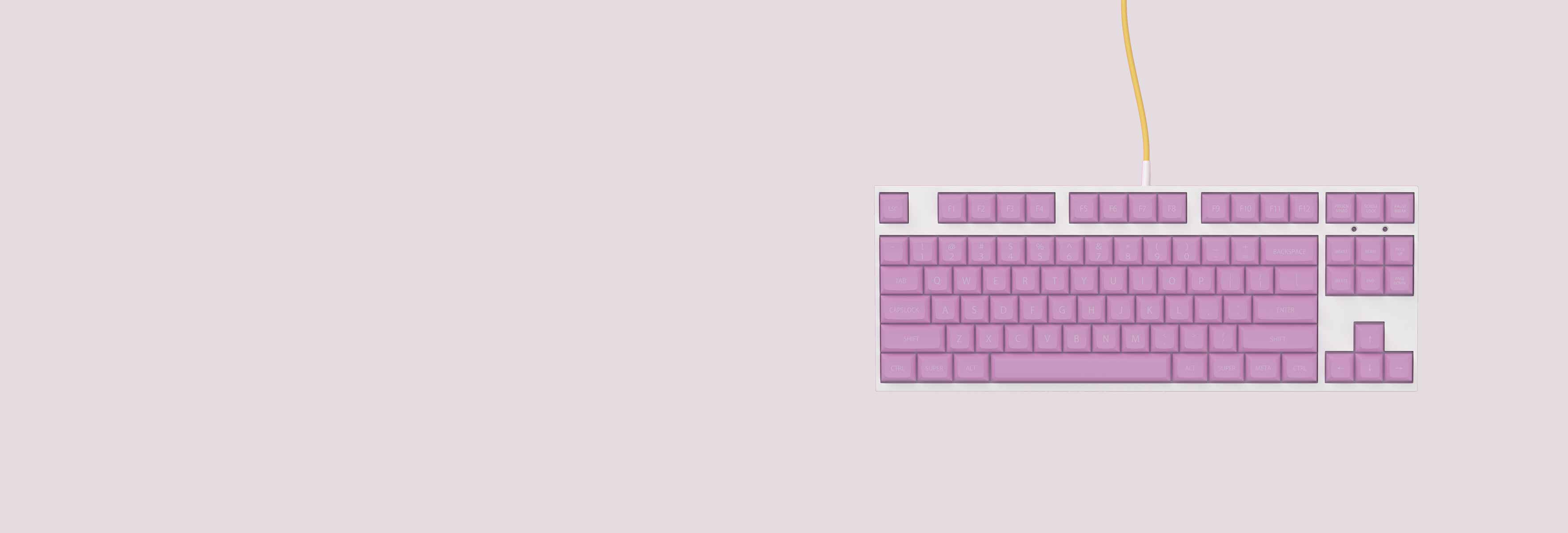 Lilla tastatur på rosa bakgrunn
